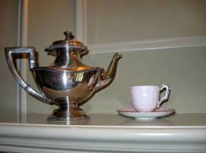 1920s silver teapot and cup and saucer on display at the Ainsley House in Campbell, CA.